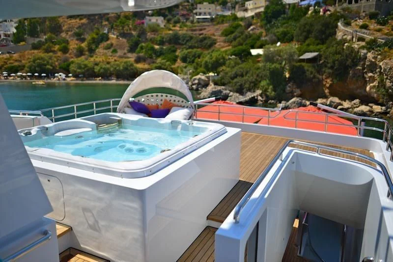 a pool with a view of a city and trees aboard UNEXPECTED Yacht for Sale