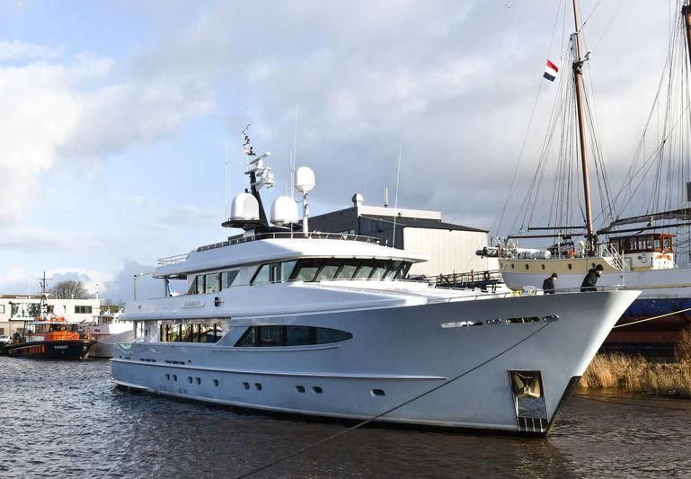 a large white boat with a smaller boat in it aboard UNEXPECTED Yacht for Sale