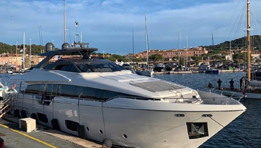 a white yacht in a harbor aboard SOKNY Yacht for Sale