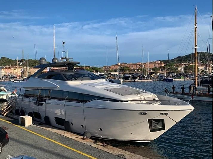 a large white yacht docked at a pier aboard SOKNY Yacht for Sale