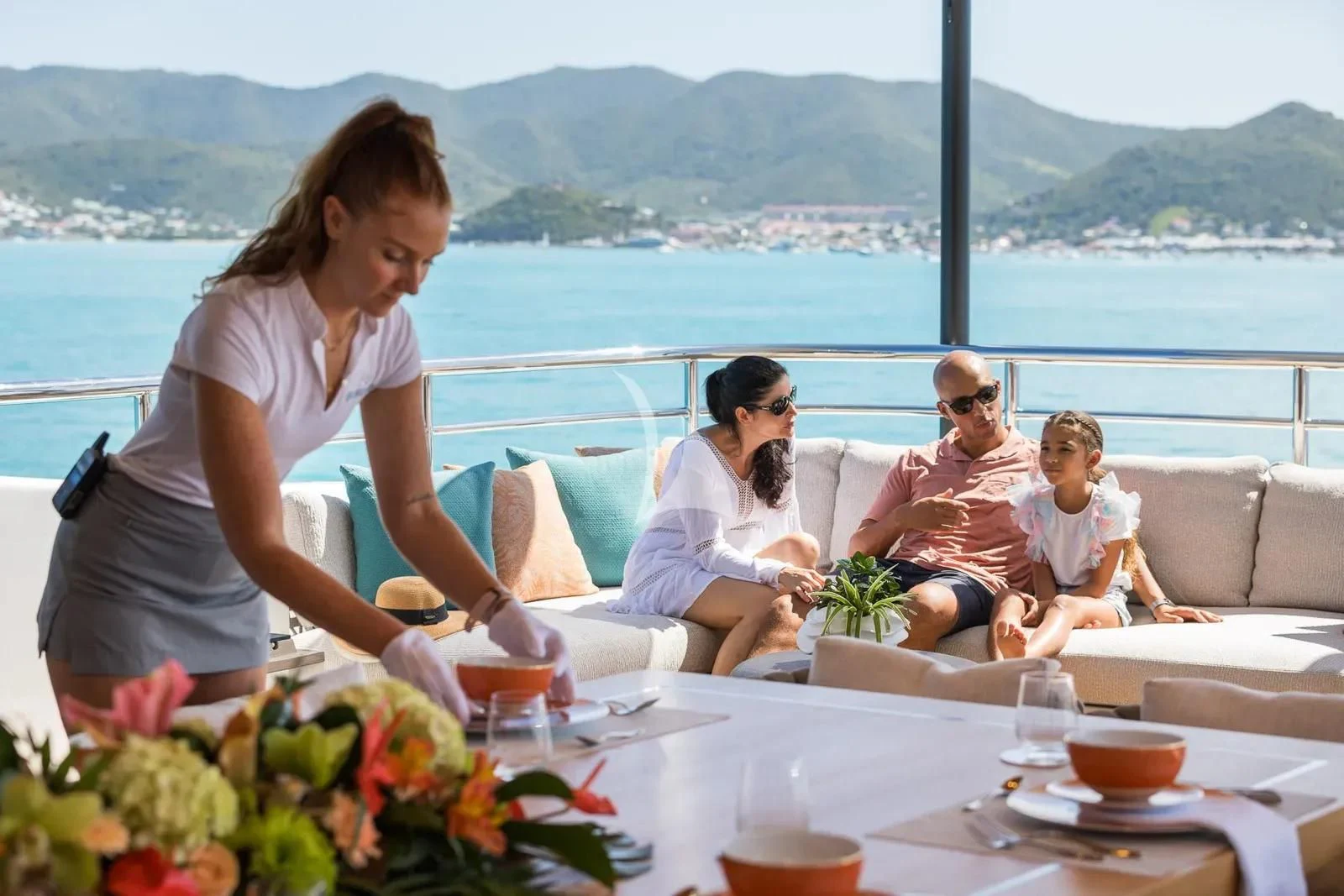 a group of people sitting on a couch on a balcony aboard BIRUBI Yacht for Sale
