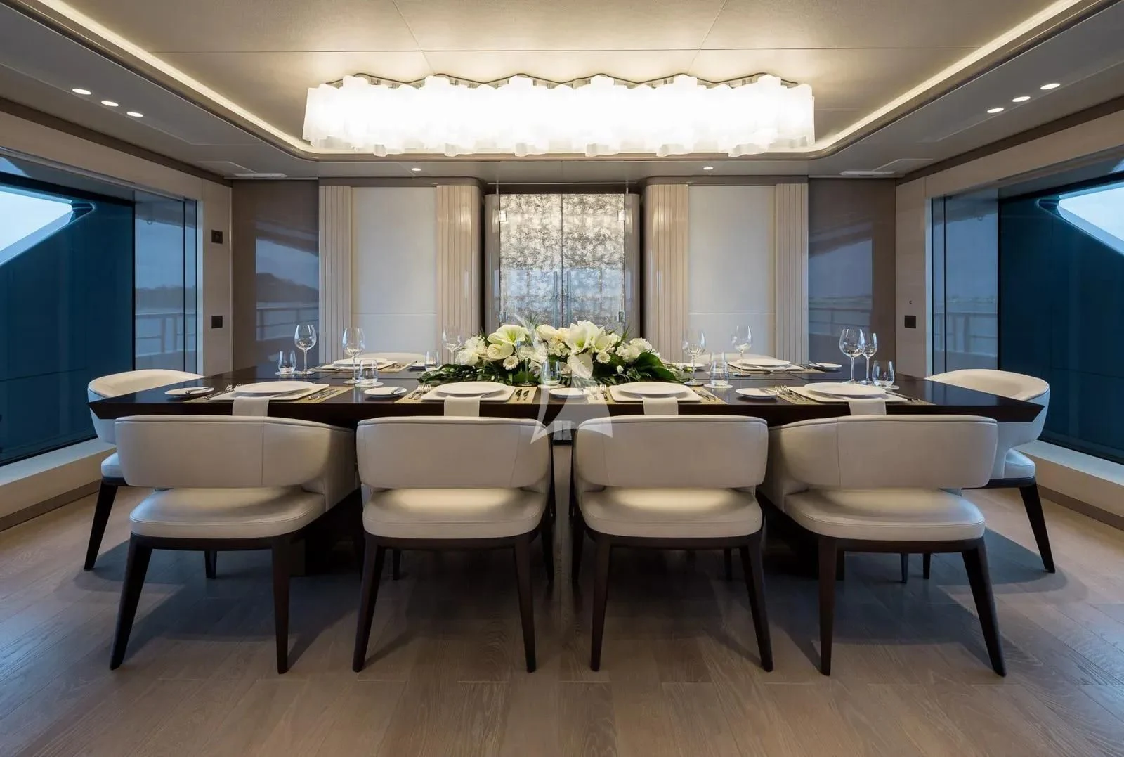 a large room with tables and chairs aboard BIRUBI Yacht for Sale