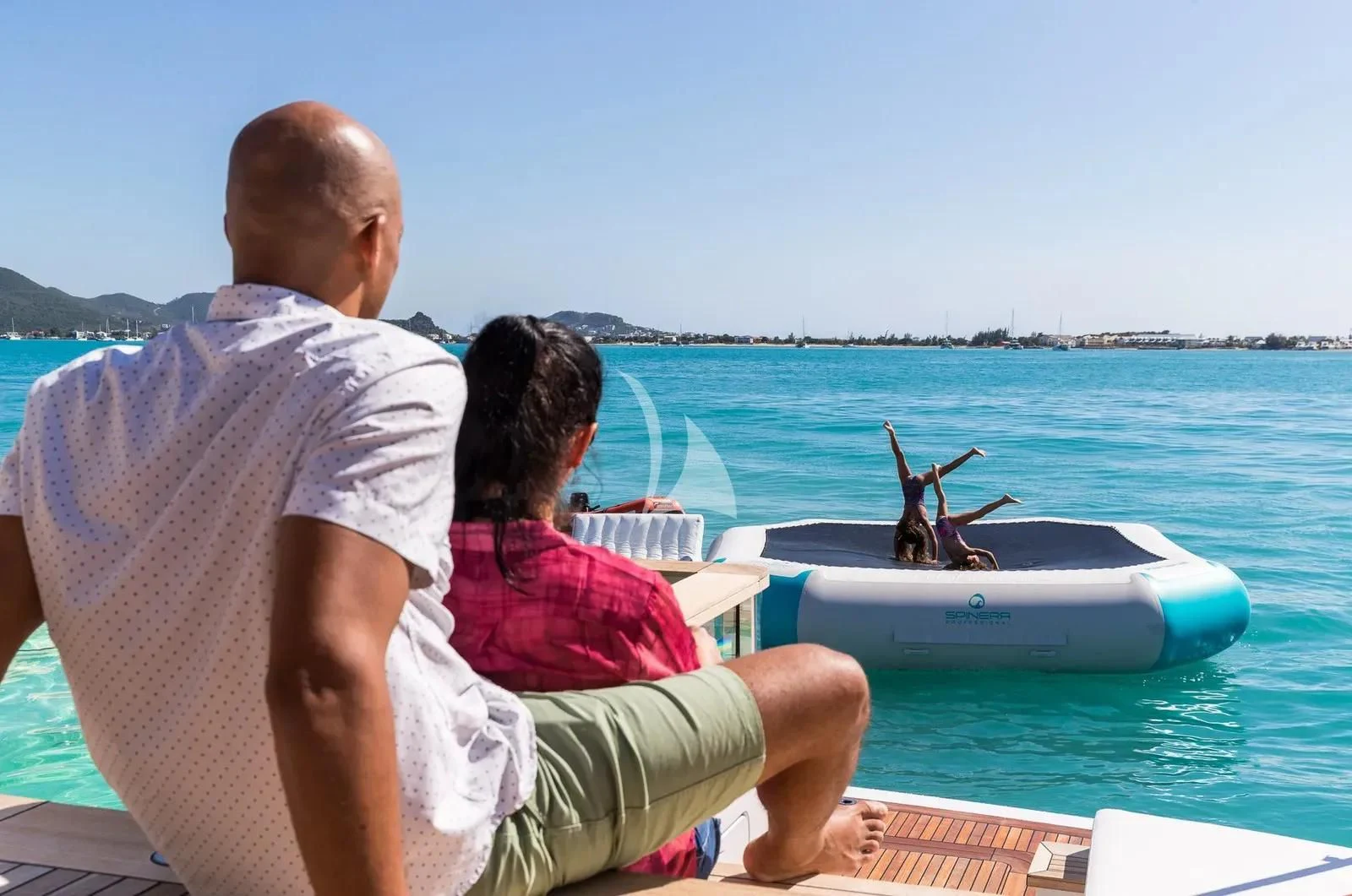 a man and a woman sitting on a boat in the water aboard BIRUBI Yacht for Sale