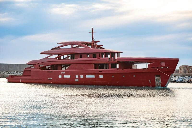 a red boat in the water aboard BIRUBI Yacht for Sale