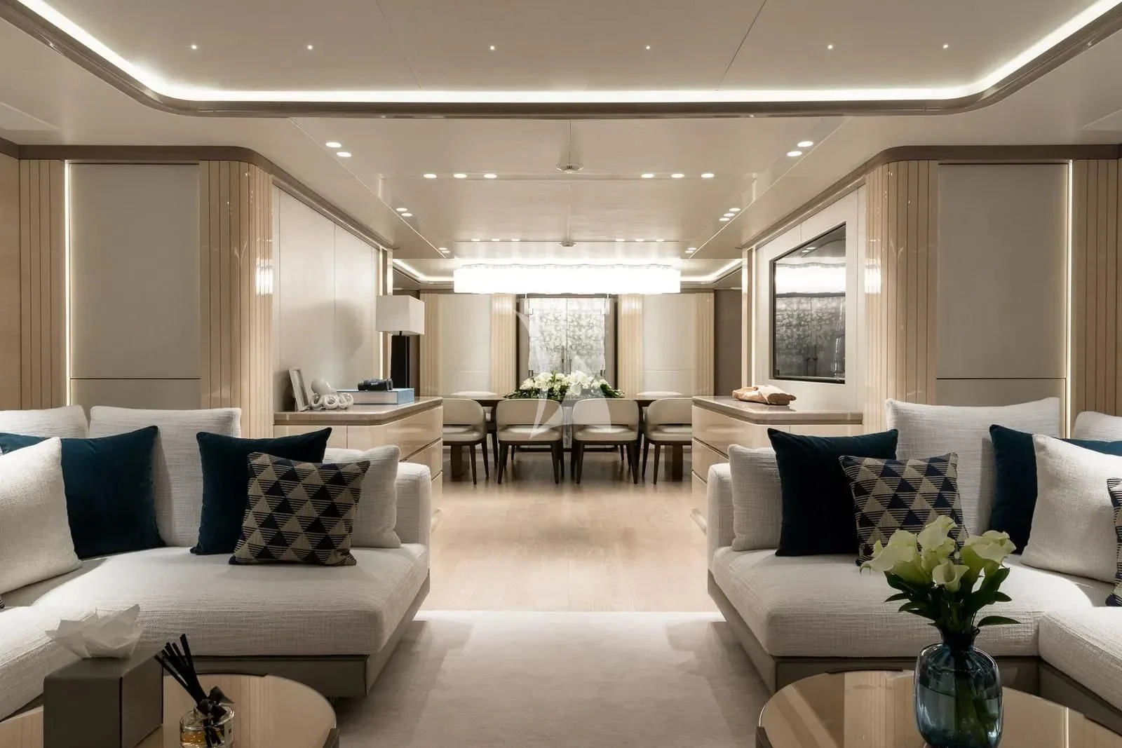a living room with white couches and a table aboard BIRUBI Yacht for Sale
