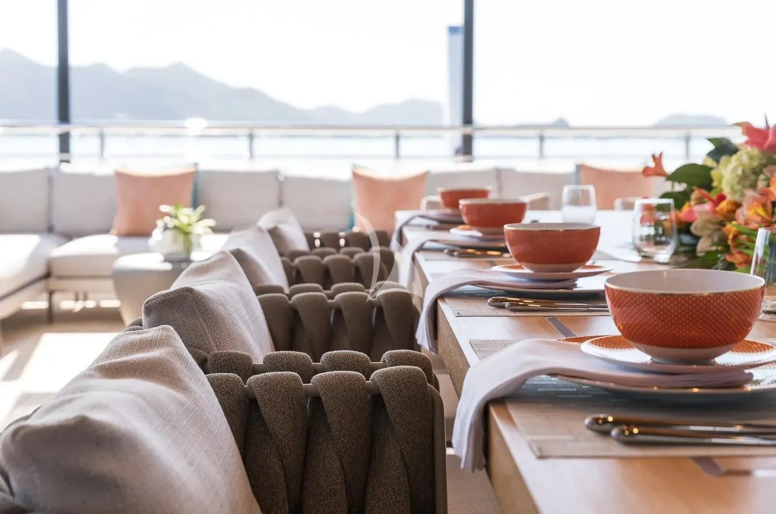 a table with plates and cups on it aboard BIRUBI Yacht for Sale