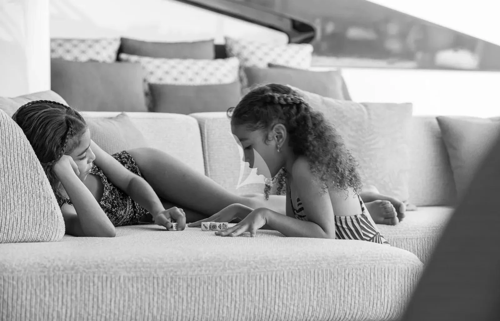a woman and a child on a couch aboard BIRUBI Yacht for Sale