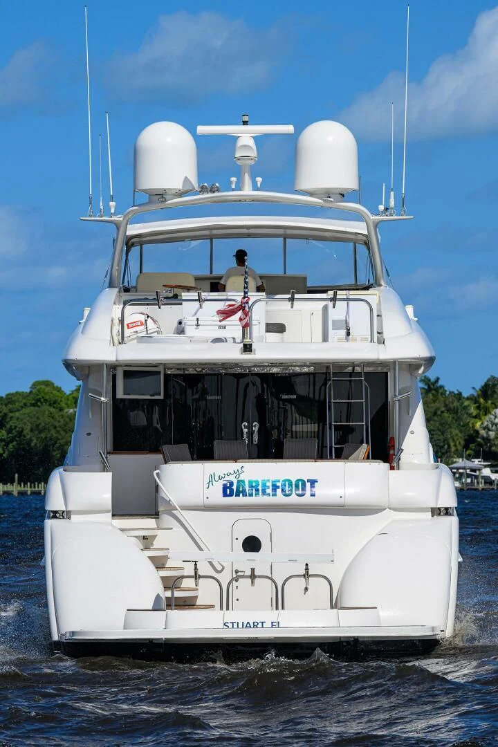 a white boat with a person on the front aboard ALWAYS BAREFOOT Yacht for Sale