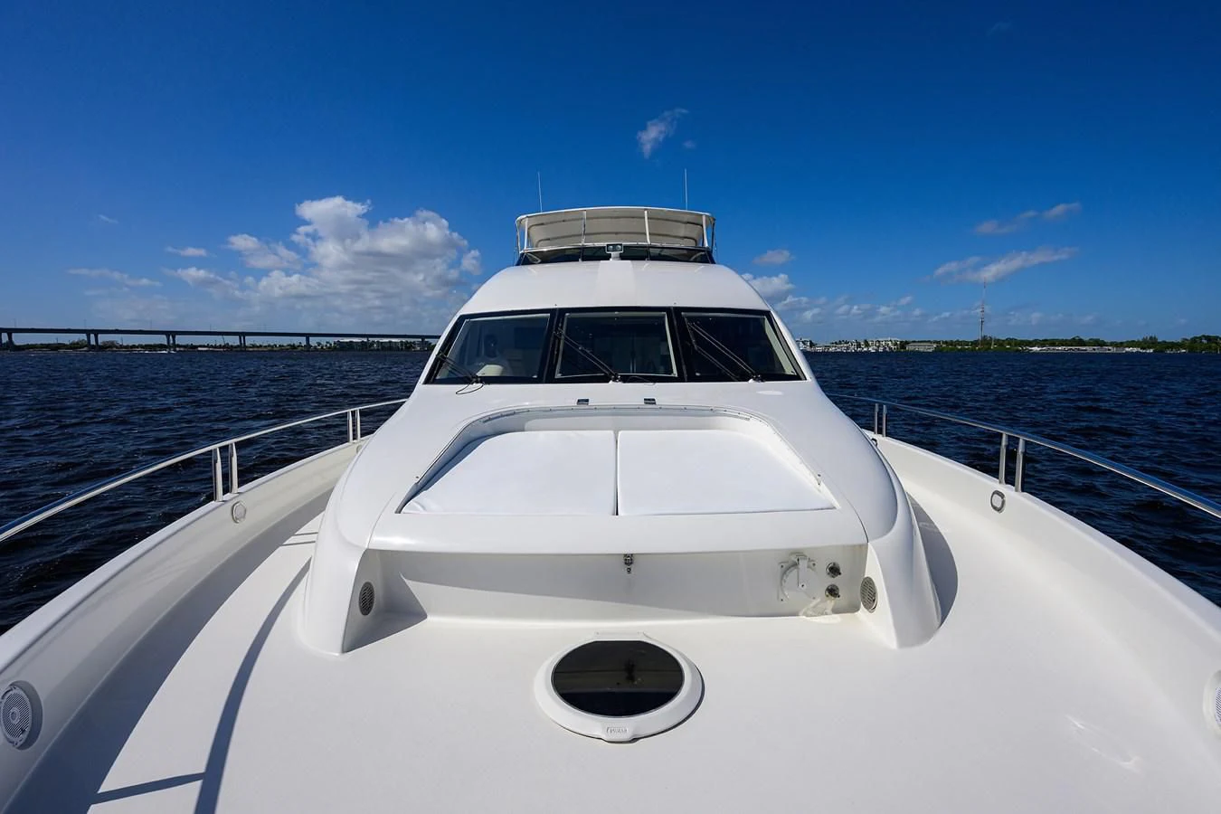 a white boat on a body of water aboard ALWAYS BAREFOOT Yacht for Sale
