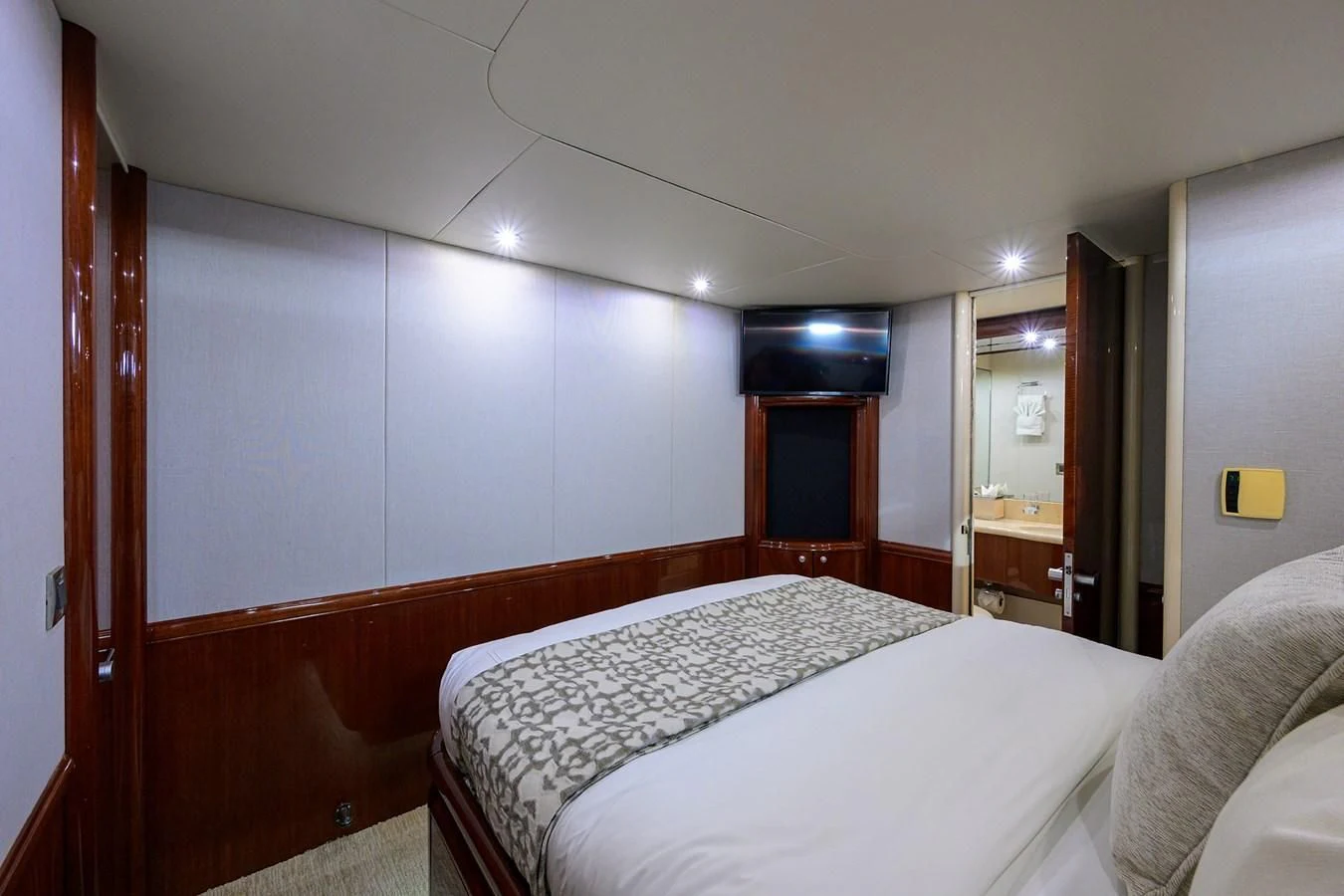 a bedroom with a bed and a mirror aboard ALWAYS BAREFOOT Yacht for Sale