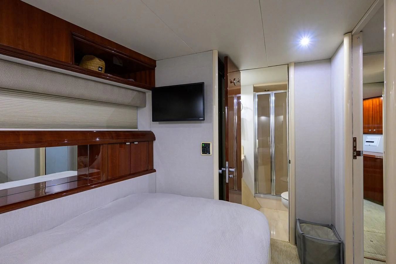a bedroom with a bed and a television on the wall aboard ALWAYS BAREFOOT Yacht for Sale
