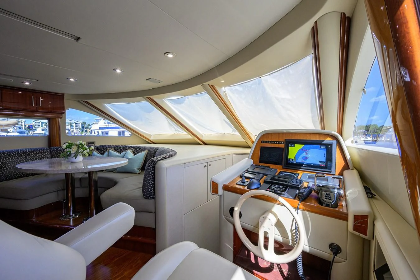 a small living room with a small television and a table aboard ALWAYS BAREFOOT Yacht for Sale