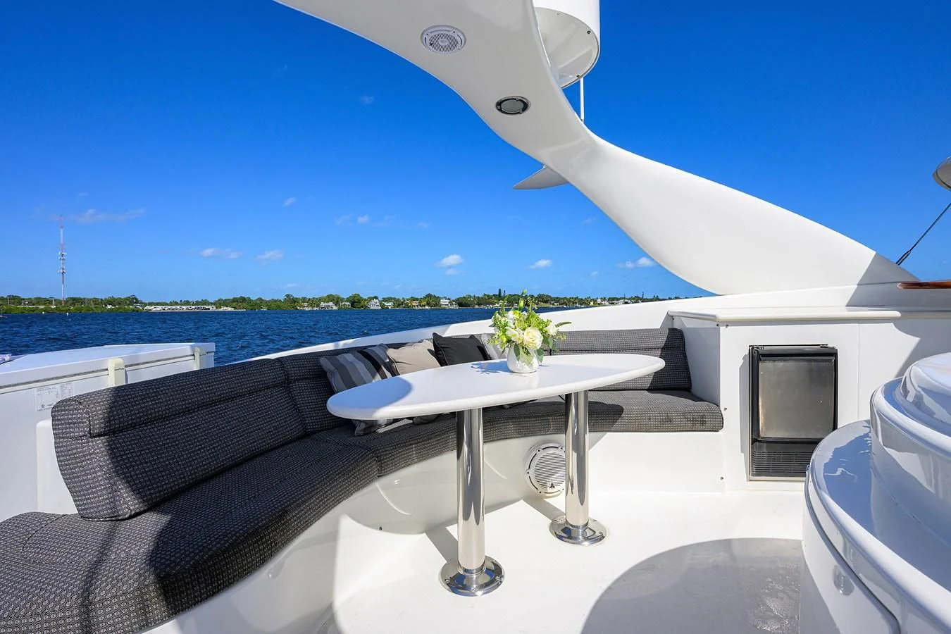 a white boat with a table and chairs on it aboard ALWAYS BAREFOOT Yacht for Sale