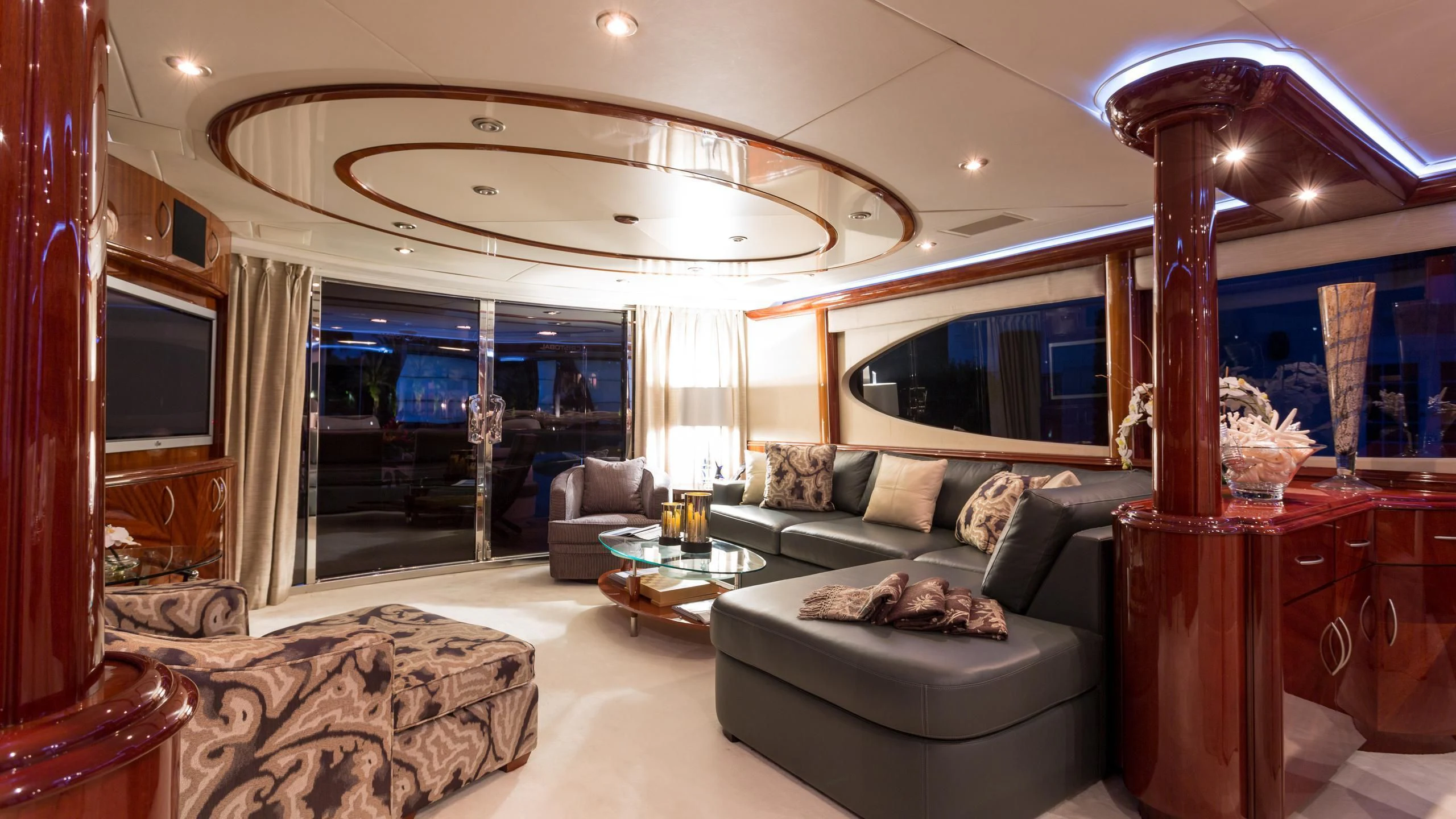 a living room with a large chandelier aboard ALWAYS BAREFOOT Yacht for Sale