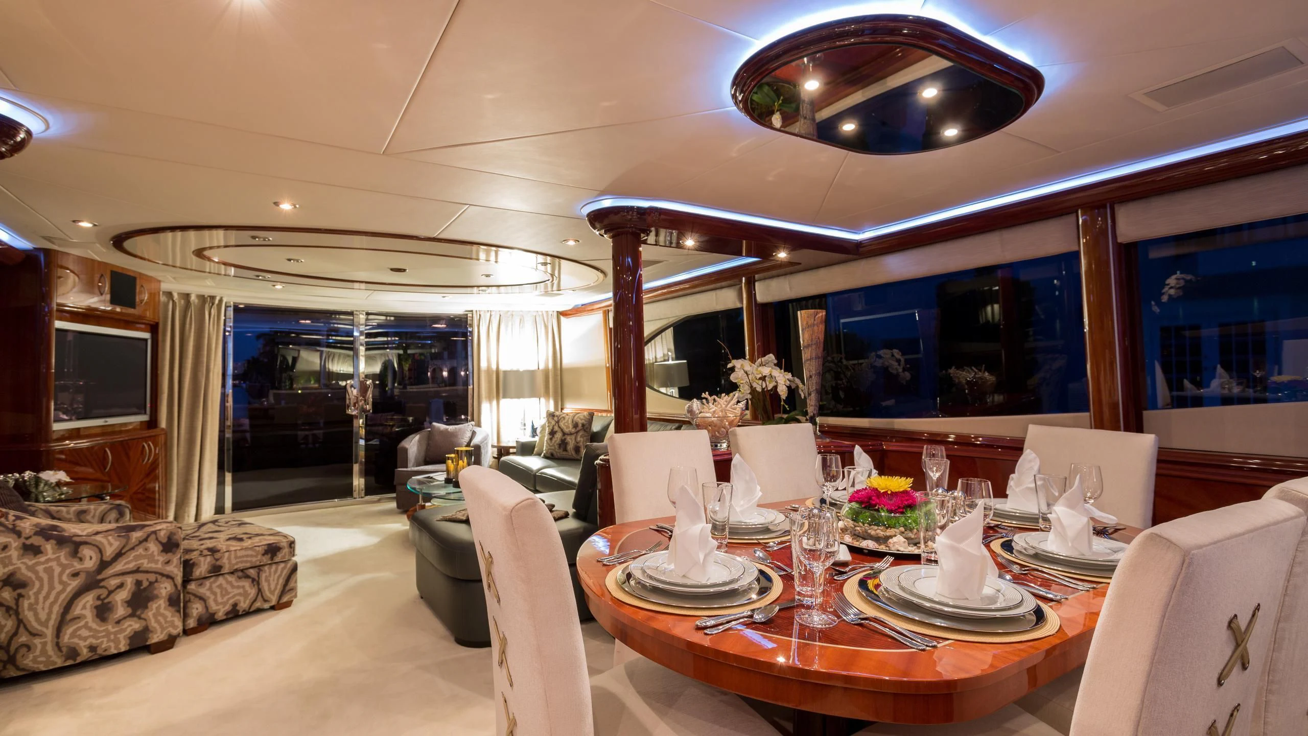 a room with a table chairs and a couch aboard ALWAYS BAREFOOT Yacht for Sale