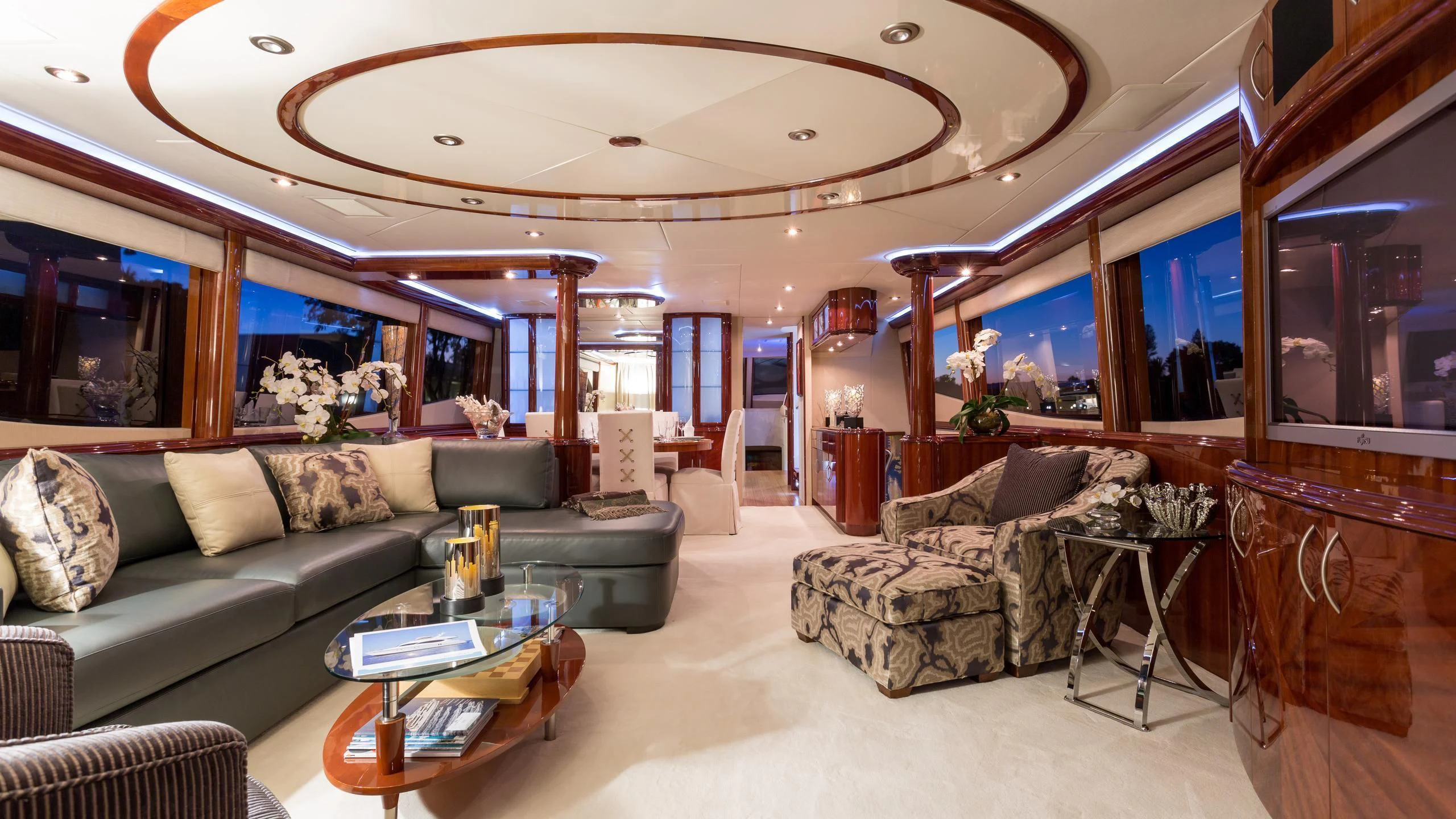 a living room with a large chandelier aboard ALWAYS BAREFOOT Yacht for Sale