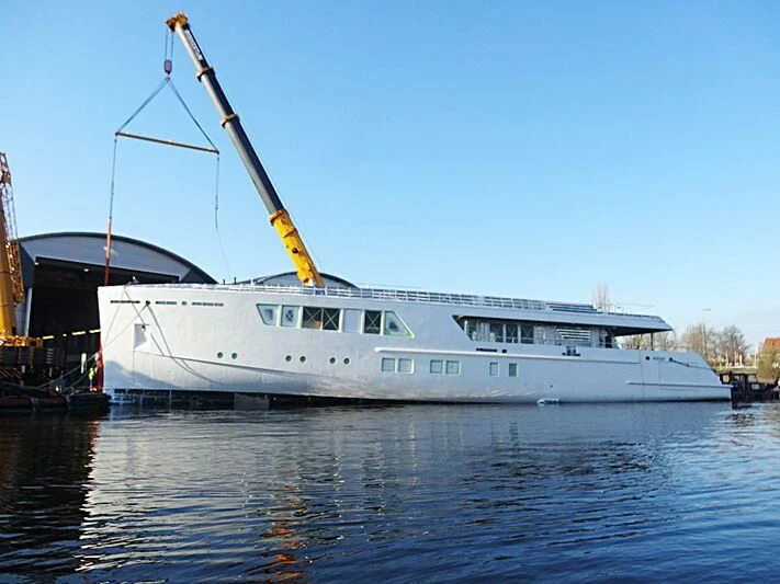 a large white boat in a harbor aboard CALLISTO Yacht for Sale