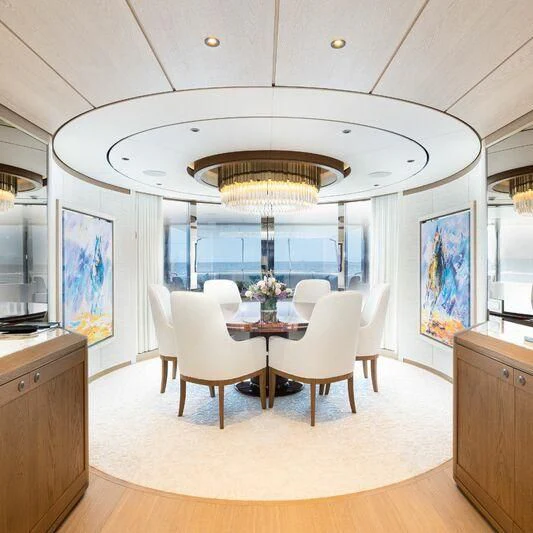 a large dining room with a chandelier aboard CALLISTO Yacht for Sale