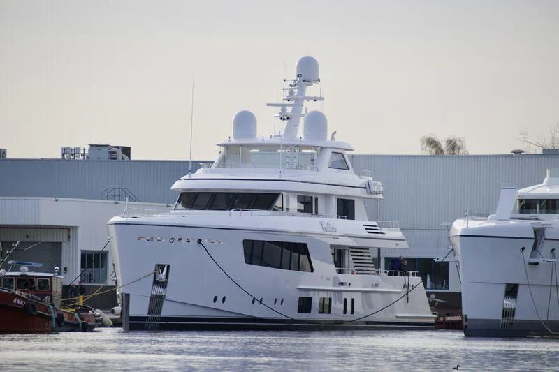 a large white boat in a harbor aboard CALLISTO Yacht for Sale