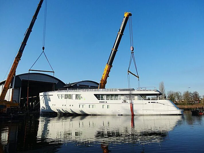 a large white boat in a harbor aboard CALLISTO Yacht for Sale