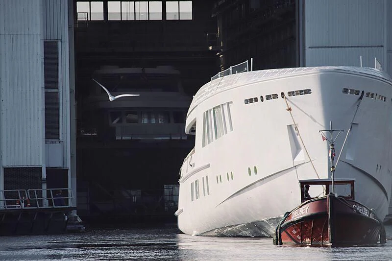 a large white boat sits in a dock aboard CALLISTO Yacht for Sale