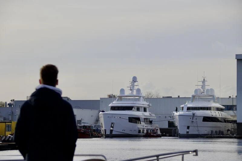 a person looking at a large ship aboard CALLISTO Yacht for Sale