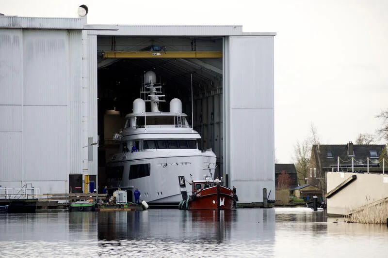 a large white ship docked aboard CALLISTO Yacht for Sale