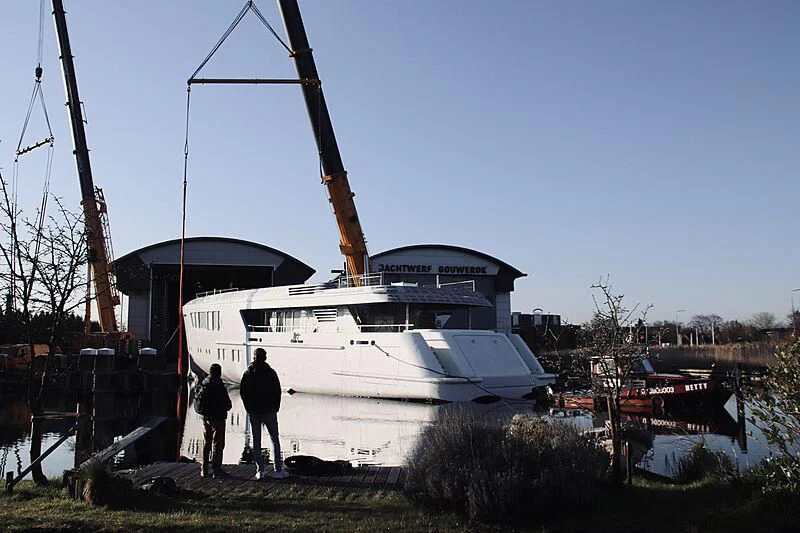 a couple of people standing next to a boat aboard CALLISTO Yacht for Sale