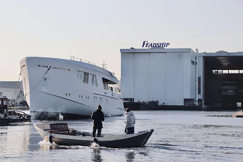 a couple of men standing on a boat in the water aboard CALLISTO Yacht for Sale