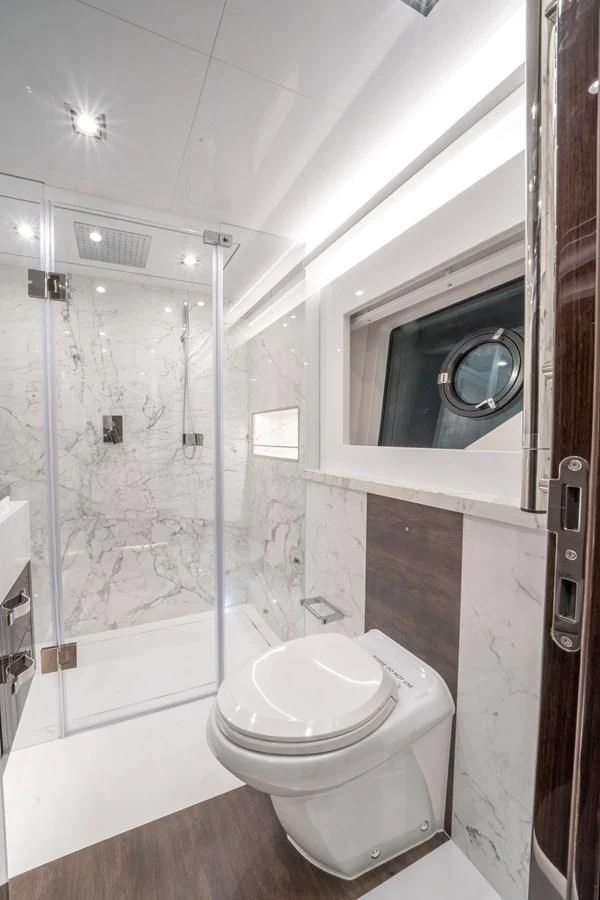 a bathroom with a toilet and a shower aboard OLIVIA RB Yacht for Sale