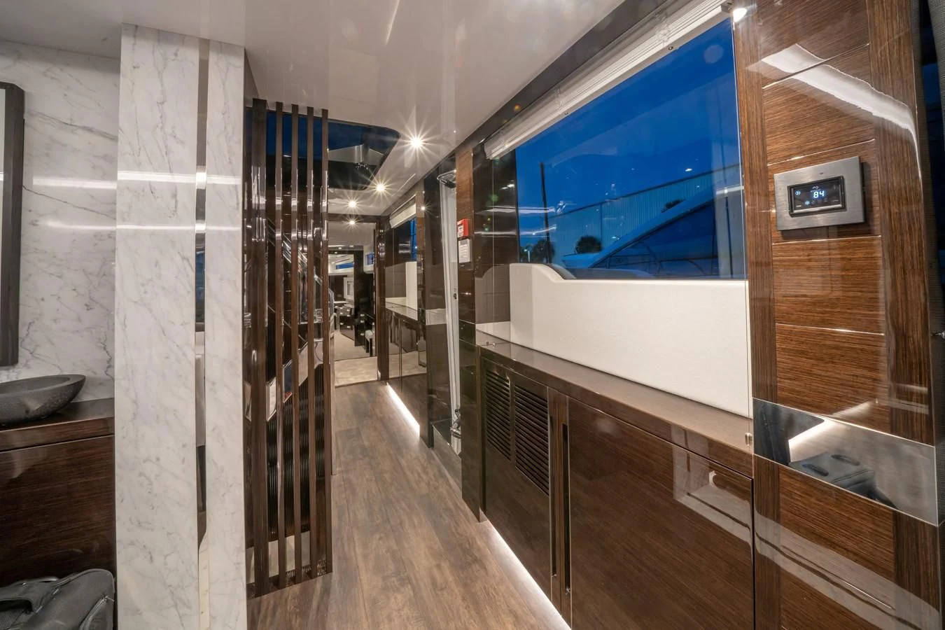 a room with a large mirror and a wood floor aboard OLIVIA RB Yacht for Sale