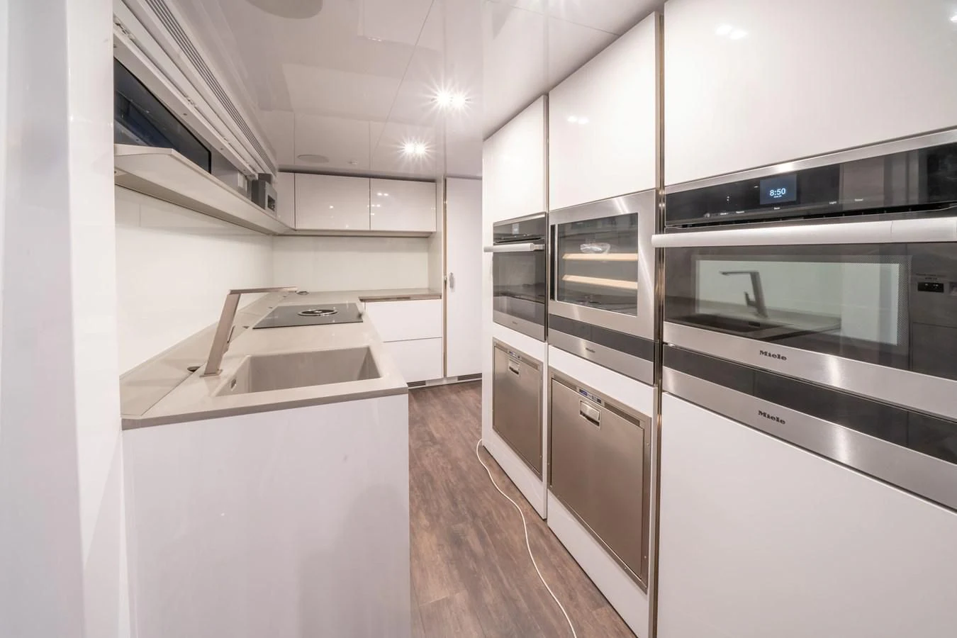 a kitchen with white cabinets aboard OLIVIA RB Yacht for Sale