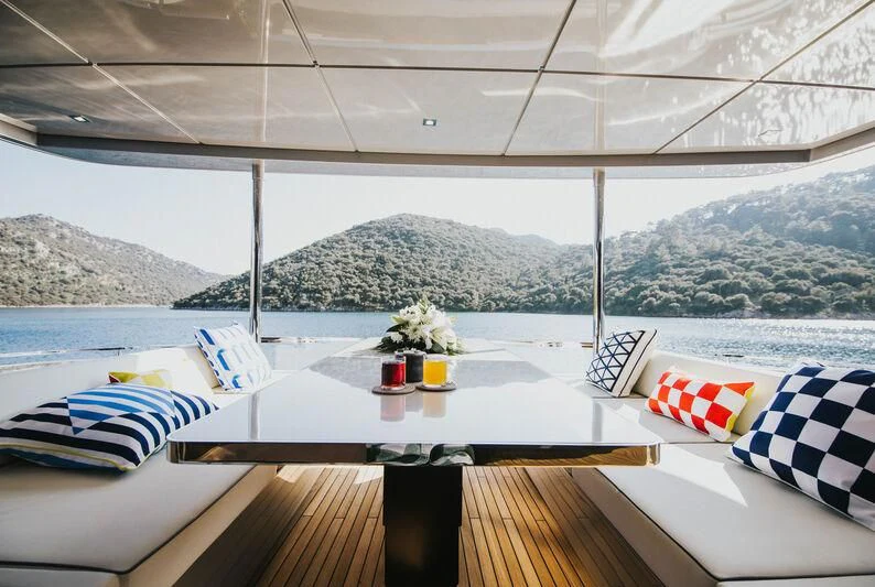 a room with a table and chairs aboard MY WAY V Yacht for Sale