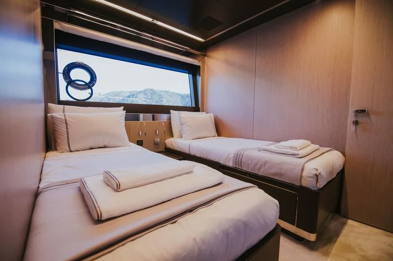 a room with beds and a window aboard MY WAY V Yacht for Sale