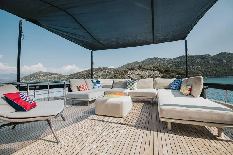 a patio with couches and pillows aboard MY WAY V Yacht for Sale