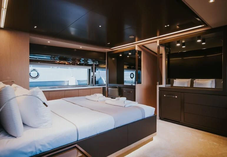 a room with a bed and cabinets aboard MY WAY V Yacht for Sale