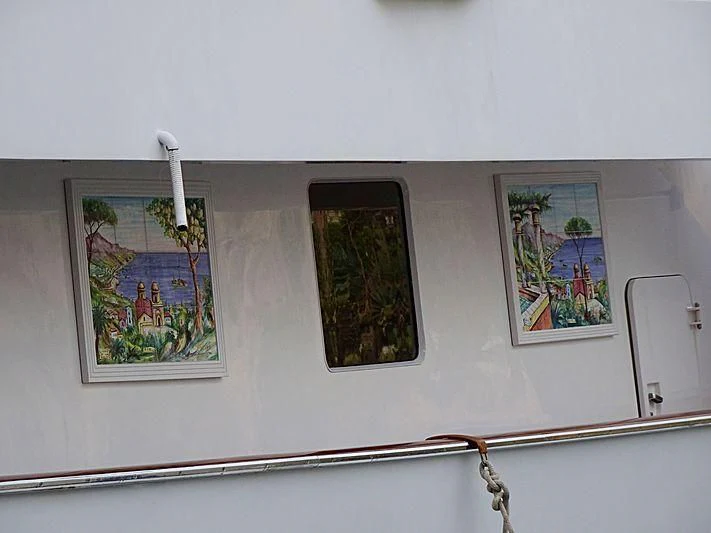 a wall with pictures on it aboard BAHIRA II Yacht for Sale