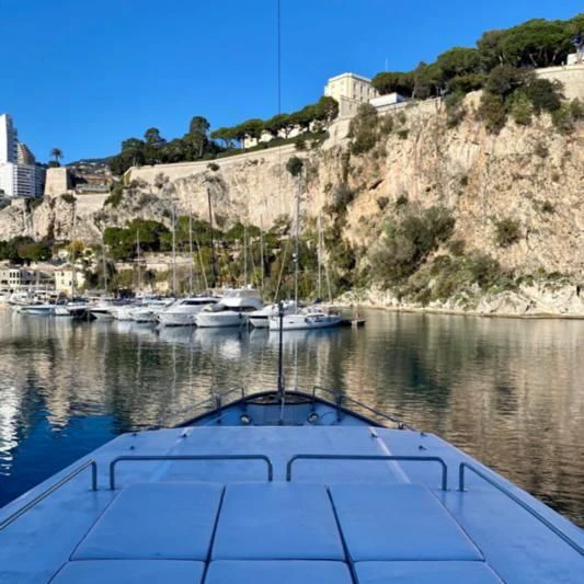 a body of water with boats in it and a cliff in the background aboard BAHIRA II Yacht for Sale