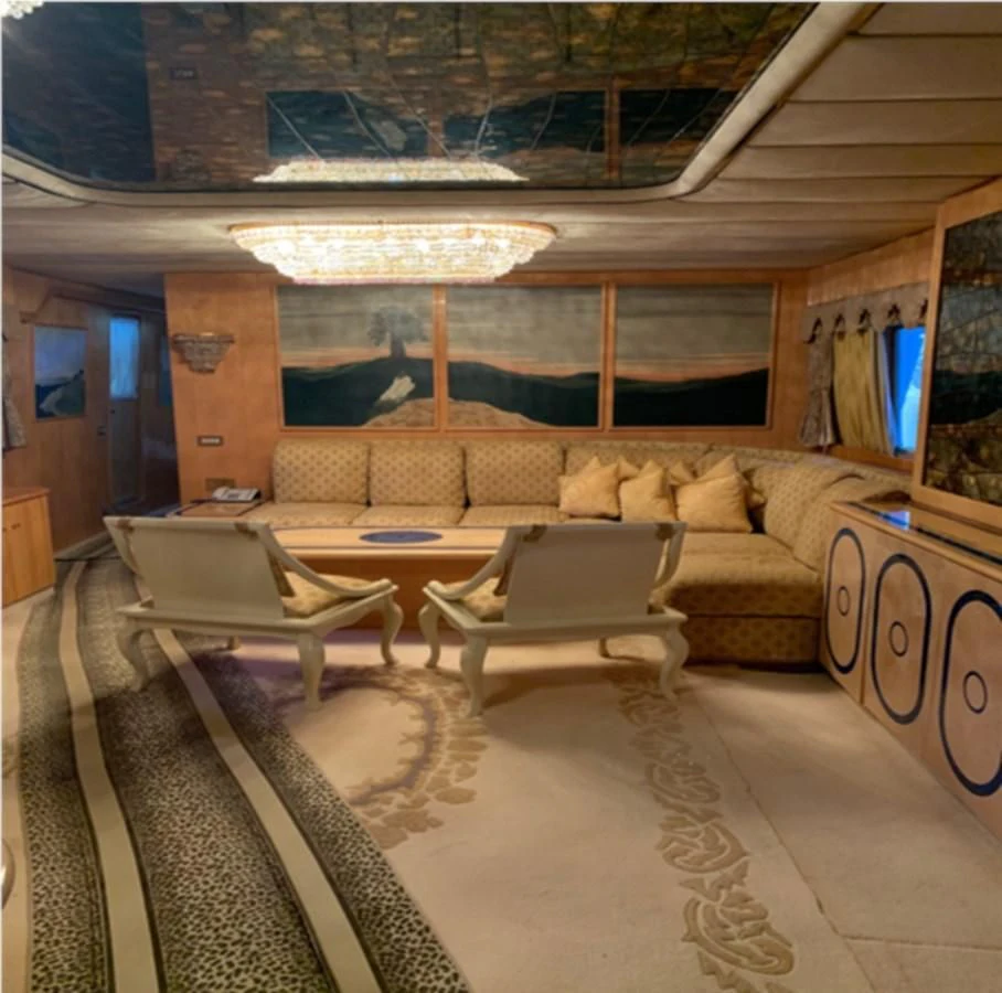 a living room with a large sofa aboard BAHIRA II Yacht for Sale