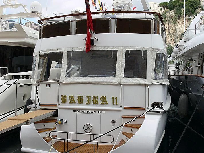 a white boat with a red bow aboard BAHIRA II Yacht for Sale