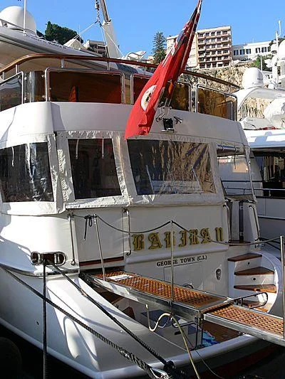 a boat with a flag on the front aboard BAHIRA II Yacht for Sale