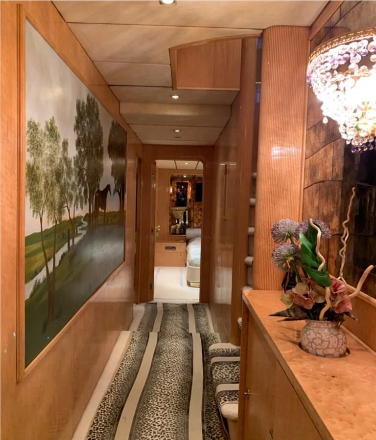 a room with a large window and a table with plants on it aboard BAHIRA II Yacht for Sale