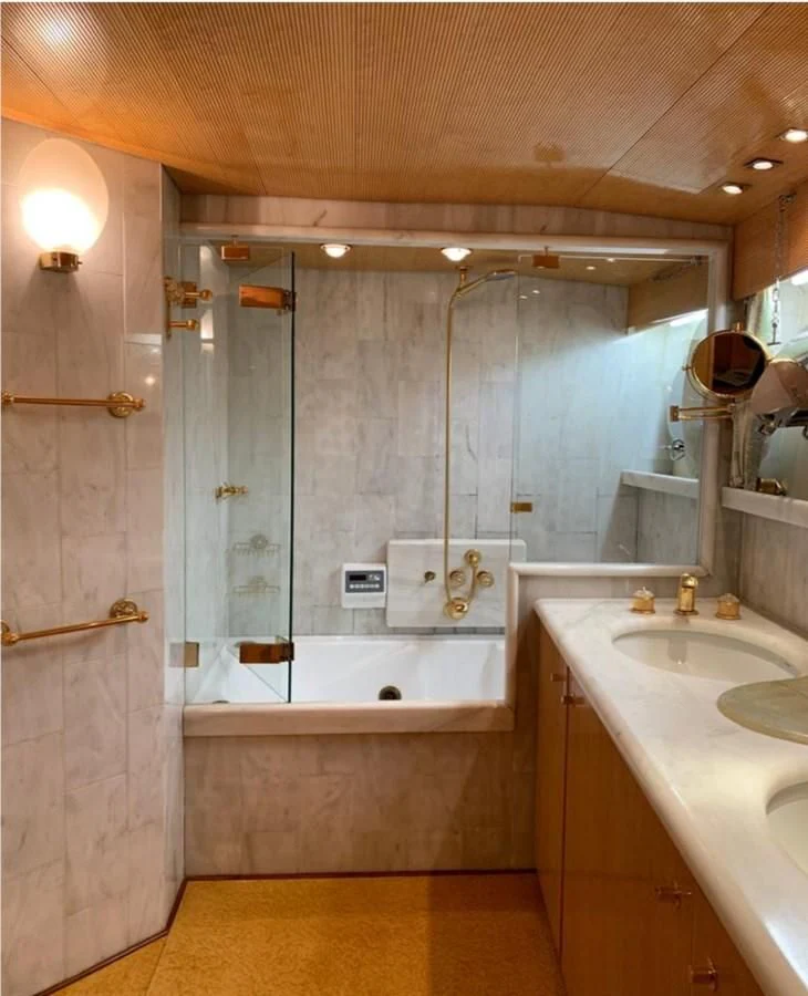 a bathroom with a bathtub and sink aboard BAHIRA II Yacht for Sale