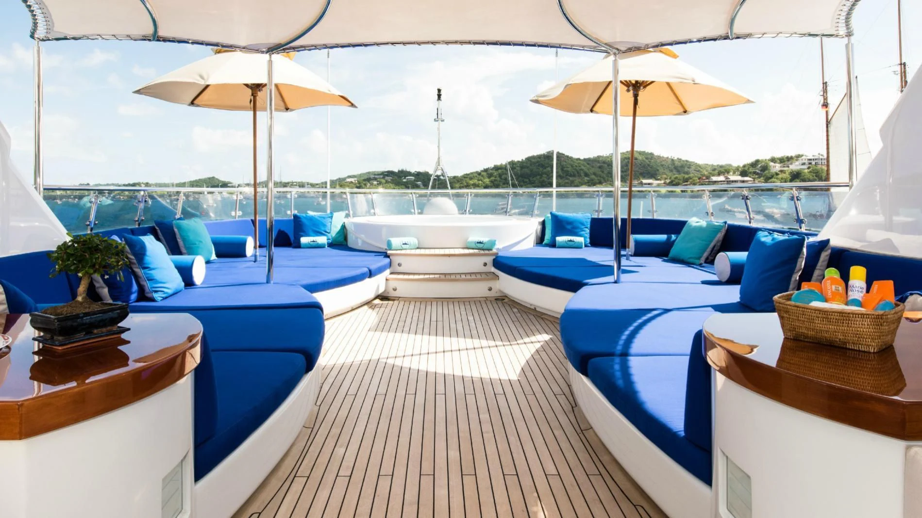 a room with a deck chairs and umbrellas aboard TALISMAN MAITON Yacht for Charter