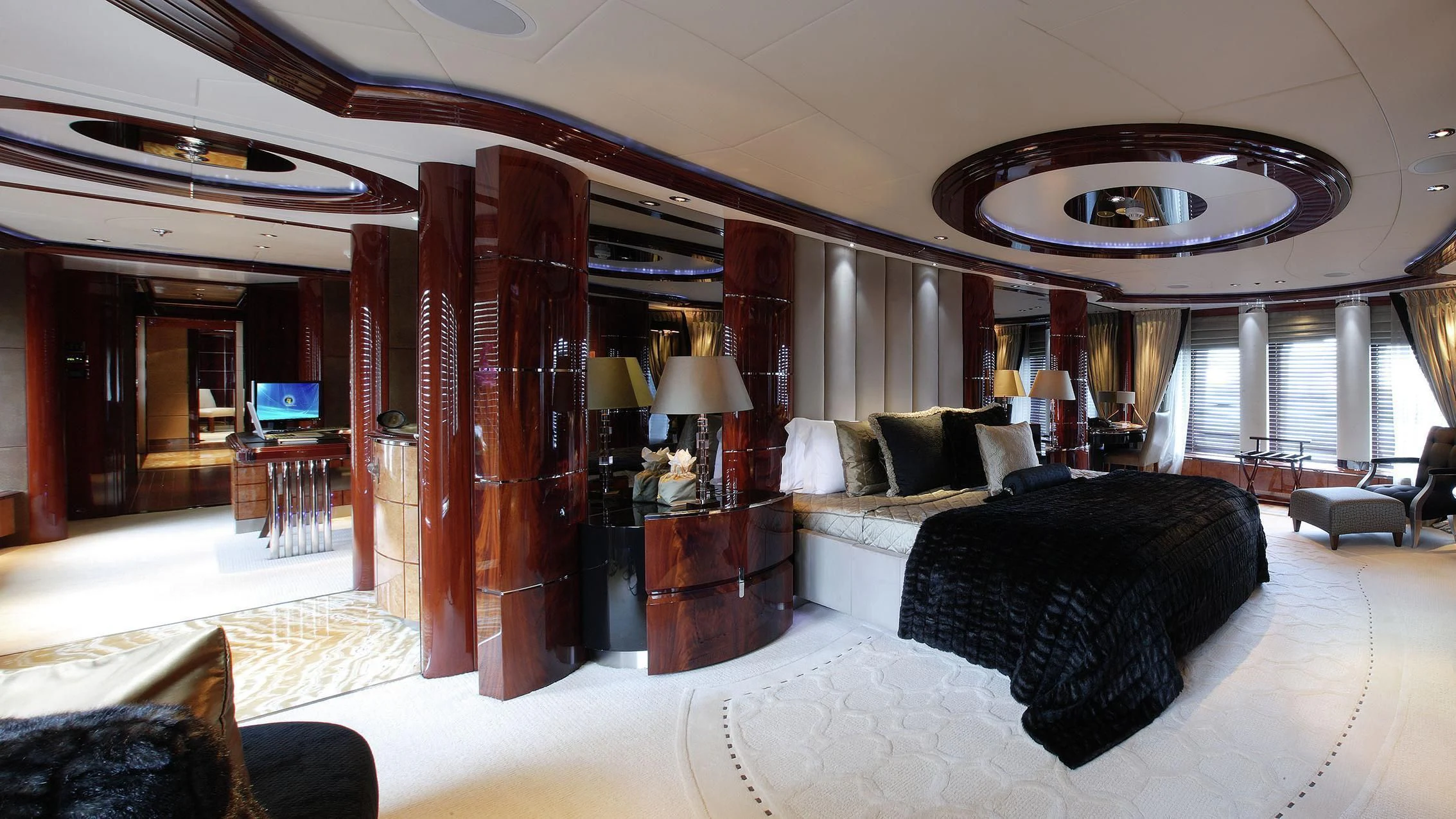 a large bedroom with a large mirror aboard TALISMAN MAITON Yacht for Charter