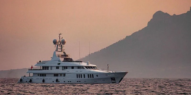 a white boat on a beach aboard TALISMAN MAITON Yacht for Charter
