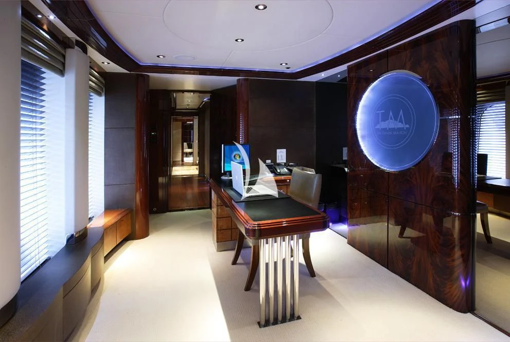 a room with a desk and a large blue sign aboard TALISMAN MAITON Yacht for Charter