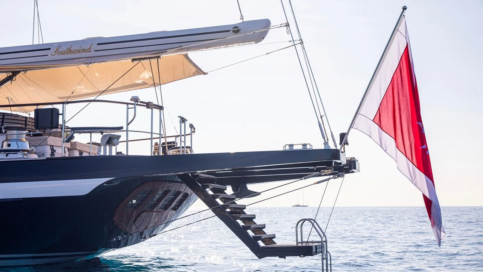 a boat with a flag on it aboard SOUTHWIND OF Yacht for Sale
