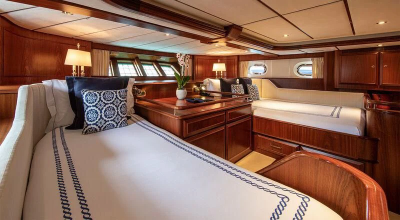 a room with a bed and desk aboard SOUTHWIND OF Yacht for Sale
