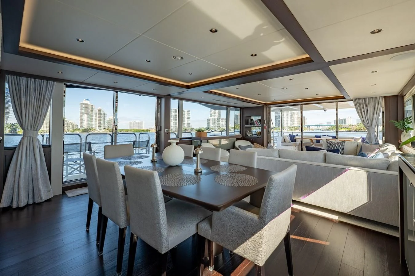a large dining table in a room aboard ROMANI Yacht for Sale